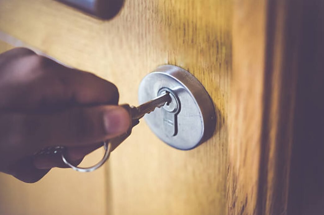 Residential locksmith service in Reynoldsburg, Ohio - Professional locksmith unlocking a home door